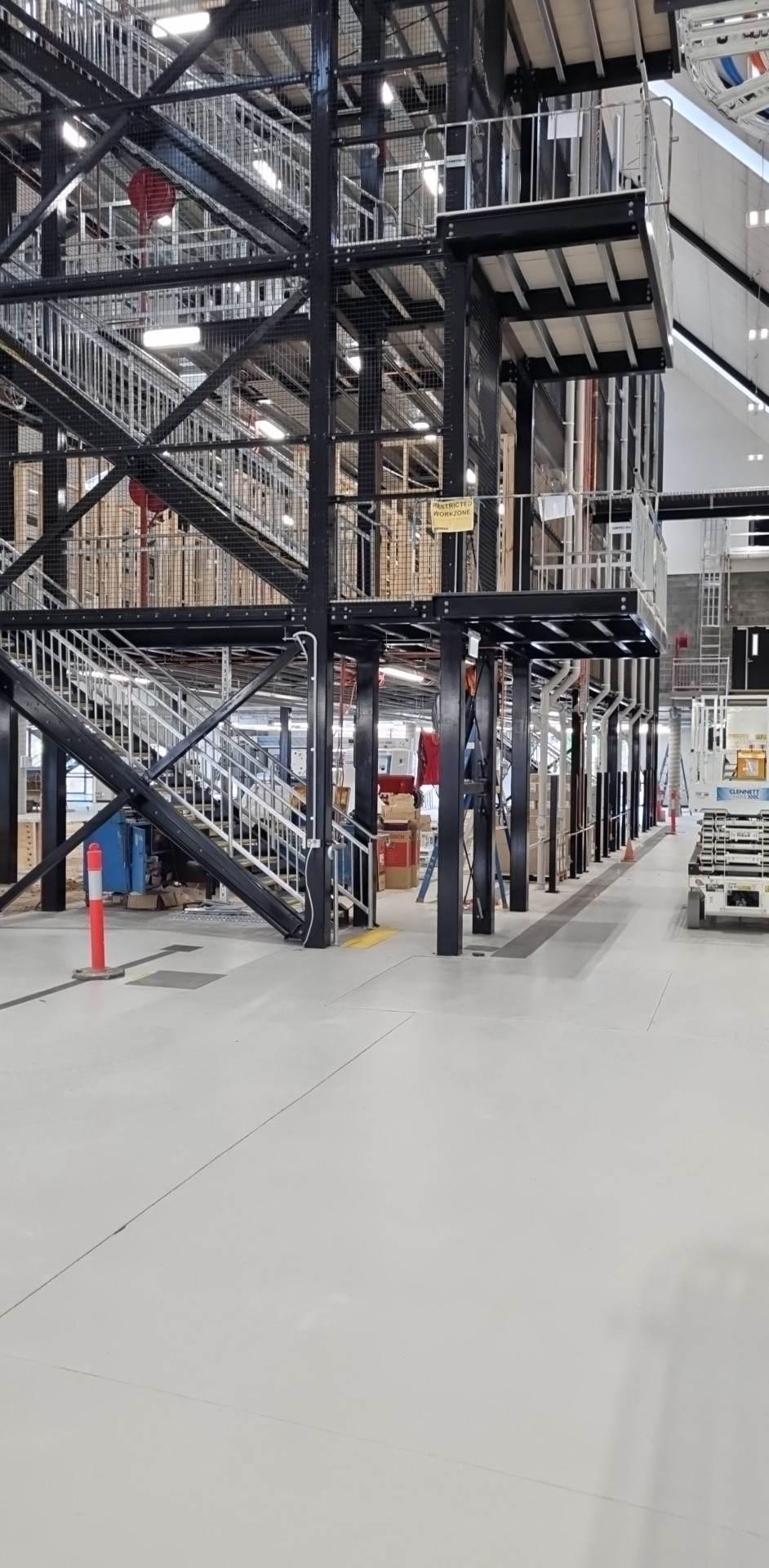 The four-stop shaft rising through the mezzanine levels
