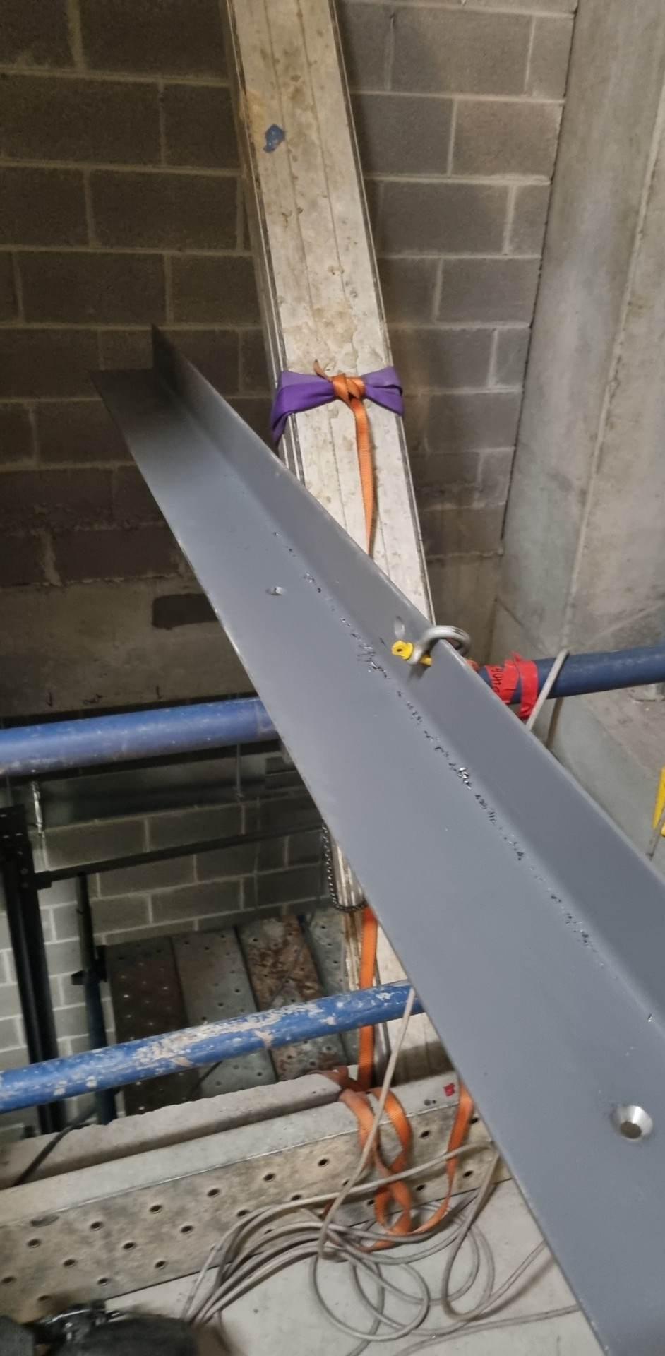 Guide steel slung into position inside the lift shaft